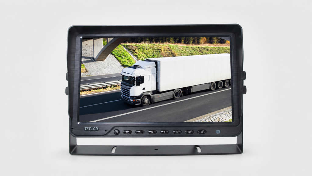 Black bracket-mounted vehicle monitor displaying a white tractor-trailer on a road