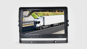 Black bracket-mounted vehicle monitor displaying a white tractor-trailer on a road