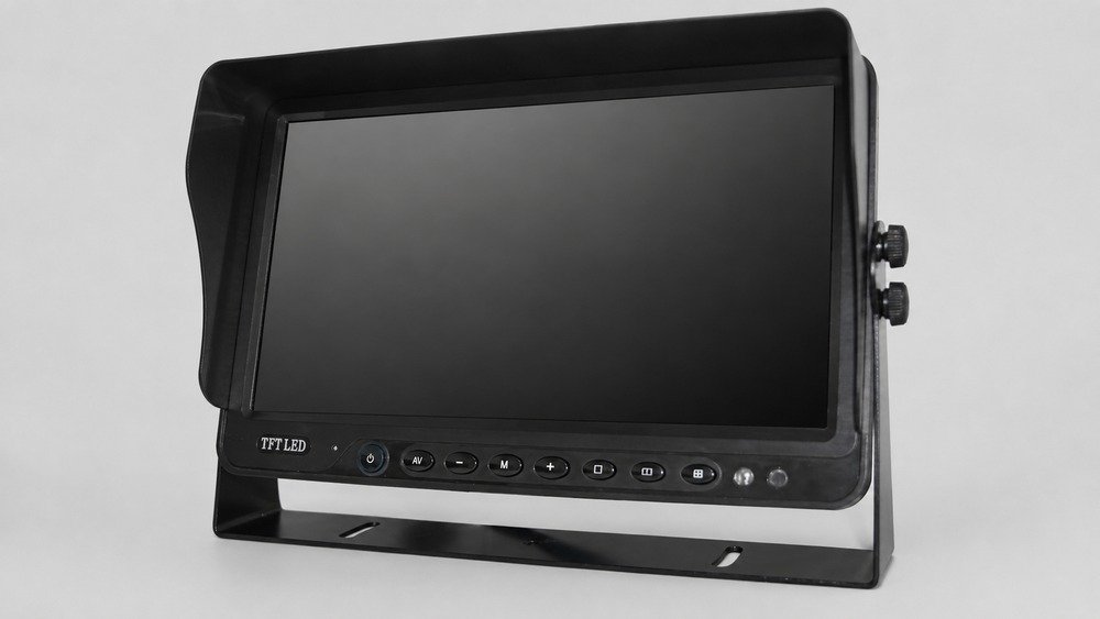 Black bracket-mounted vehicle monitor with a dark screen, sunshade, control buttons, side knobs, and U-shaped metal stand